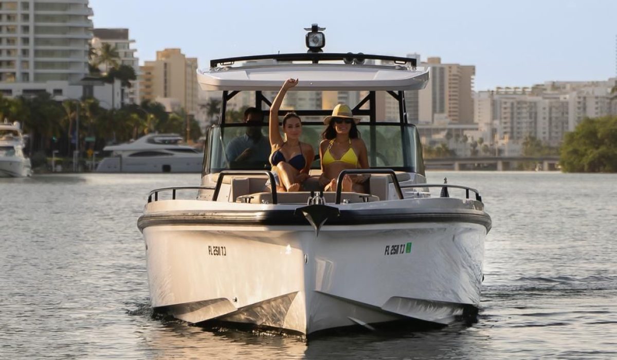 lady waving hands on 38' Axopar yacht